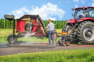 Farmer cleaning equipment with pressure washer rental